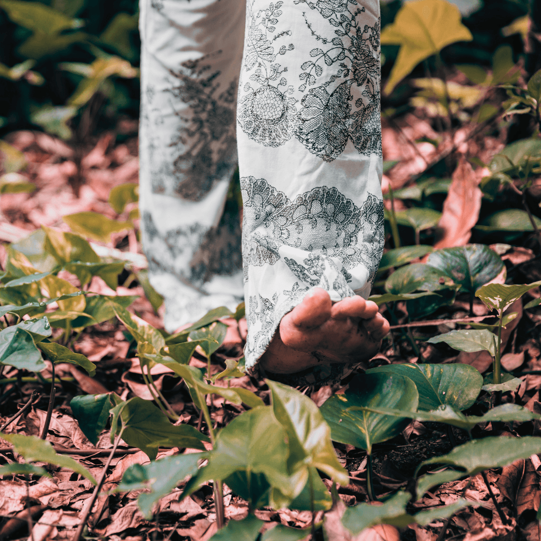Woman walking barefoot in the forest.