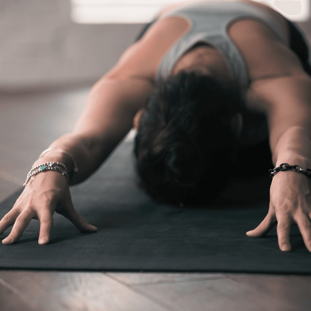 Woman doing child’s pose in yoga.