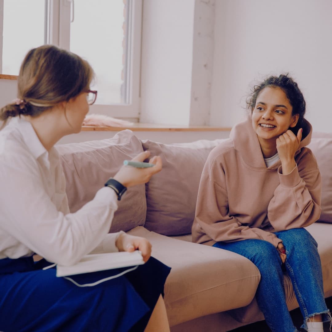 Cycle coach guiding a client in a supportive conversation about menstrual health and body awareness.